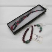 A semi precious stone necklace, an agate and amethyst bracelet and a matching pair of silver clasp