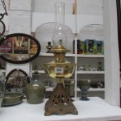 A Duplex oil lamp with brass font and cast iron base