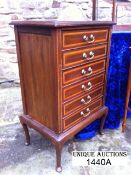 An Edwardian satinwood cross banded 6- drawer drop flap music cabinet