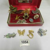 A mixed lot of costume brooches in jewellery box