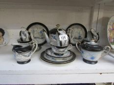 A 21 piece Japanese egg shell china tea set with Geisha in bottom of cups