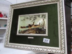 A framed enamel picture of birds (authorised replica)
