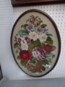 An oval framed and glazed floral wool work
 
Condition
In good condition
Veneer has slightly
