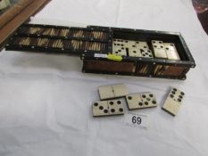 A set of old dominoes in a porcupine quill box