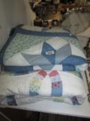 A patchwork quilt and a patchwork cot quilt
 
Condition
Blue quilt is 114cm wide x 167cm
In good
