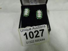 A pair of emerald and opal yellow gold earrings