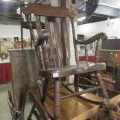 A dark stained wood Windsor style rocking chair