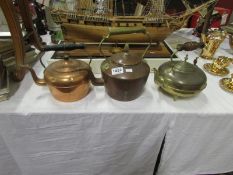 2 copper and a brass kettles