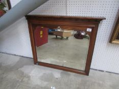 An oak framed hall mirror with cornice