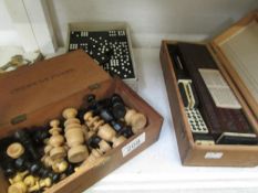 A boxed set of dominoes with cribbage board, boxed set of chess pieces and another set of dominoes