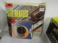 A quantity of Beatles LP and 45 rpm records including The White album with poster and photos