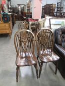 A set of 4 wheel back dining chairs