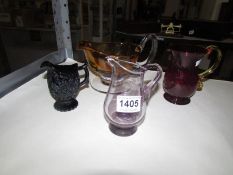 4 coloured glass jugs