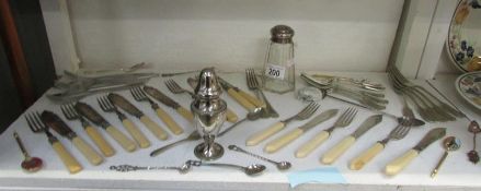 A mixed lot of cutlery together with a silver topped sugar shaker