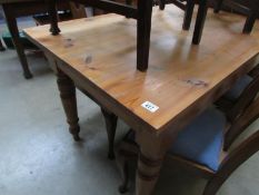 A pine kitchen table with 2 drawers