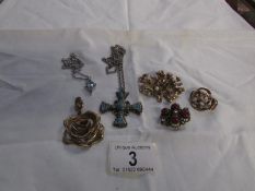A cross pendant, rose pendant, one other and 3 brooches