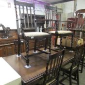An oak dining table, 2 carvers and 4 dining chairs