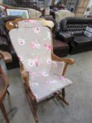 A stick back rocking chair with cushions