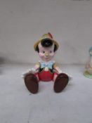 A musical porcelain Pinnochio with jointed arms and legs