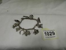 A silver charm bracelet with 10 charms