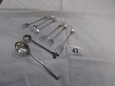 6 silver cocktail forks and silver spoon and an Indian rupee spoon