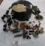 A lacquered box, 2 necklaces and a collection of stones etc