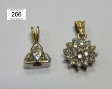 A diamond floral pendant (0.25ct) and a diamond solitaire pendant (20pt)