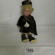 An Armande Marsaille porcelain doll in Scottish costume, 23cm