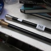 2 ebony walking sticks - 1 with silver top hallmarked and 1 silver gilt hallmarked rubbed