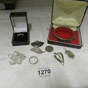 A quantity of silver jewellery including brooches and bracelet