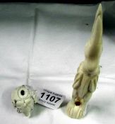 A carved ivory elephant netsuke a/f and an ivory stork