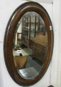 An oval framed mirror