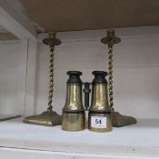 A pair of brass candlesticks and brass binoculars