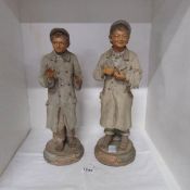 A pair of Austrian terracotta figures of poacher and friend, a/f