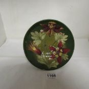 A small green Moorcroft comport with floral decoration