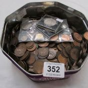 A tin of British coins, mostly copper