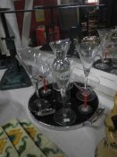 A cocktail tray with shaker and glasses