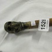 A walking stick with skull handle