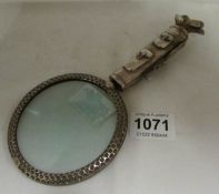 A silver plate golf themed magnifying glass