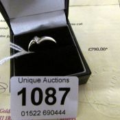 An 18ct white gold ring with Princess cut white diamond 0.15 cts with valuation certificate
