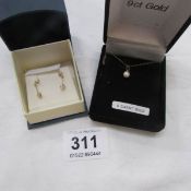 A 9ct gold pendant and pair of 9ct gold earrings