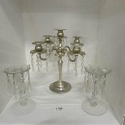 A plated candelabra with glass droppers and pair of candlesticks with droppers