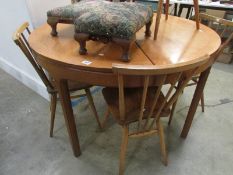 A large circular teak dining table