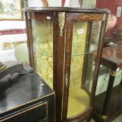 A bow front display cabinet