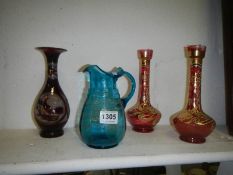 A pair of cranberry glass vases and 2 others