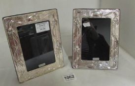 A pair of silver photo frames