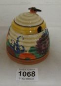A Clarice Cliff honey pot a/f (repair to wing and chip under glaze)