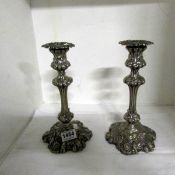 A pair of silver plated rococco style candlesticks