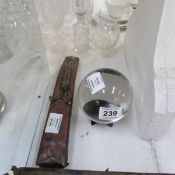 A crystal ball on stand and a Buddha copper incense burner