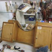 A small pine wall unit with mirror